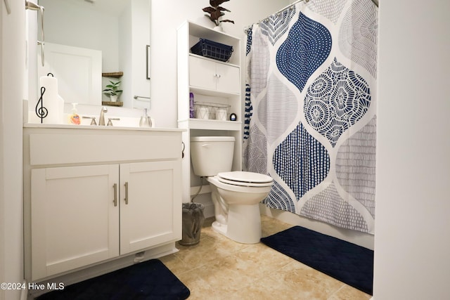 bathroom with toilet, vanity, tile patterned floors, and curtained shower