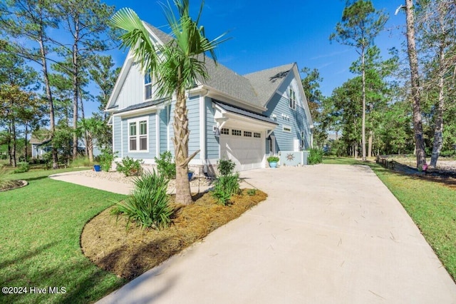 view of side of home featuring a garage, a lawn, driveway, and a shingled roof