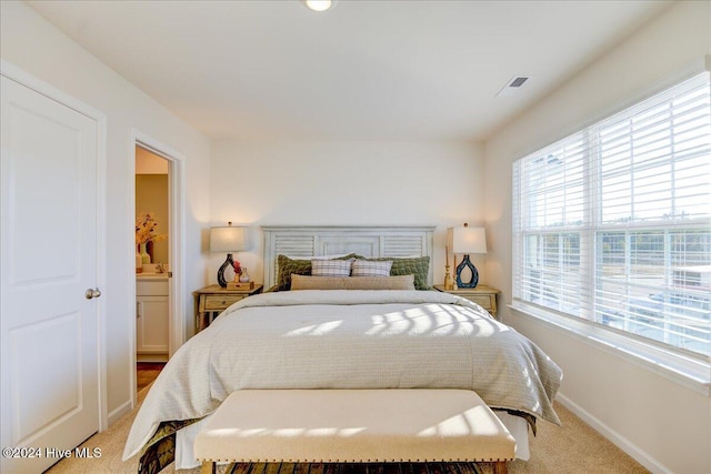 bedroom featuring light colored carpet, visible vents, and baseboards