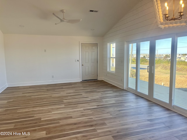 unfurnished room with wood-type flooring, high vaulted ceiling, and ceiling fan