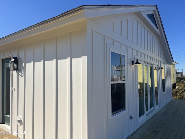 view of side of home with a wooden deck