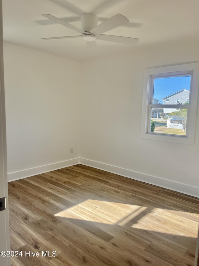 spare room featuring ceiling fan and hardwood / wood-style flooring