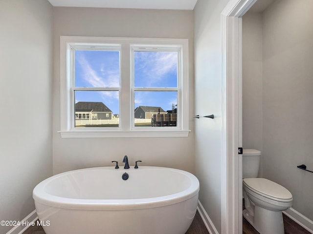 bathroom featuring a bath and toilet