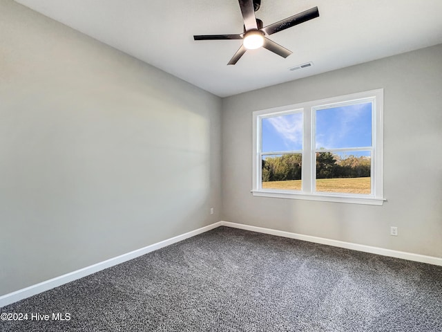 carpeted spare room featuring ceiling fan