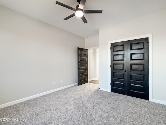 interior space featuring ceiling fan, a closet, and carpet floors