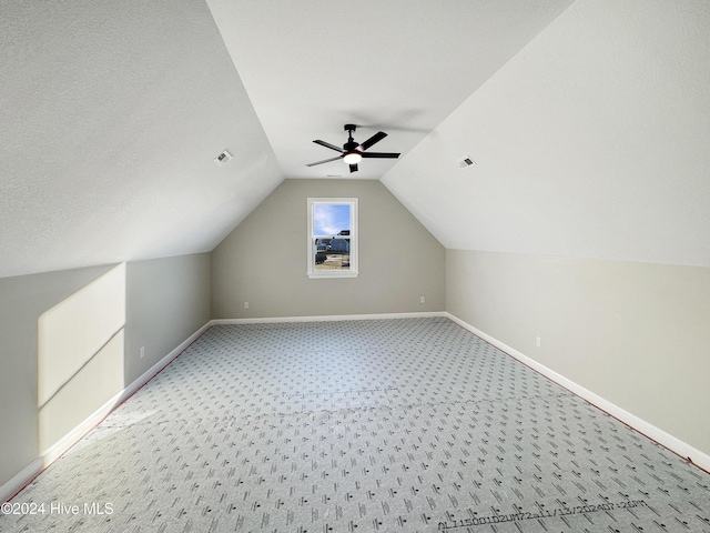 bonus room with carpet flooring, ceiling fan, a textured ceiling, and vaulted ceiling