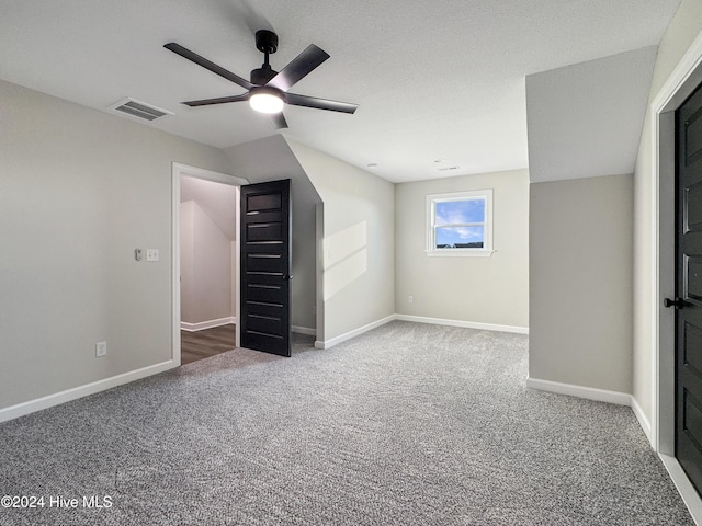 unfurnished bedroom featuring carpet flooring, ceiling fan, and lofted ceiling