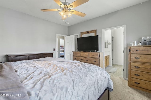 carpeted bedroom with connected bathroom and ceiling fan