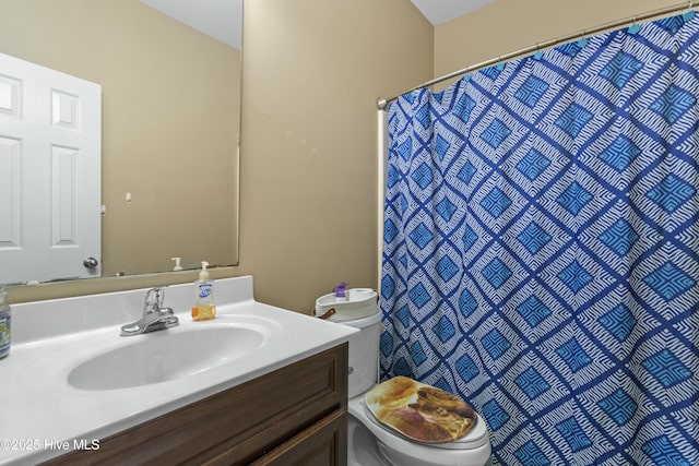 bathroom featuring vanity, toilet, and walk in shower