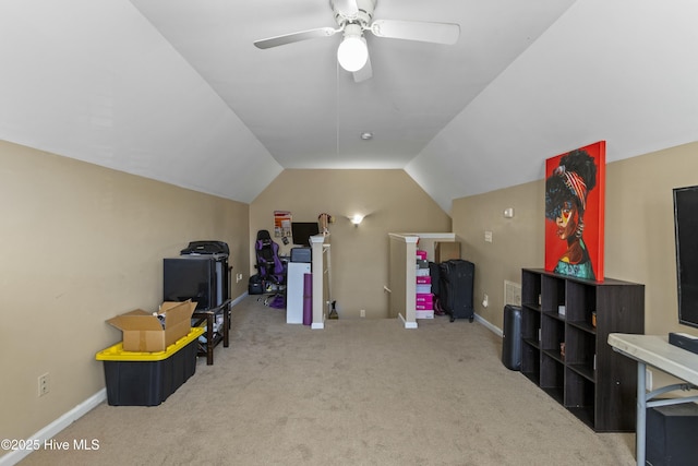 misc room with lofted ceiling, ceiling fan, and carpet flooring