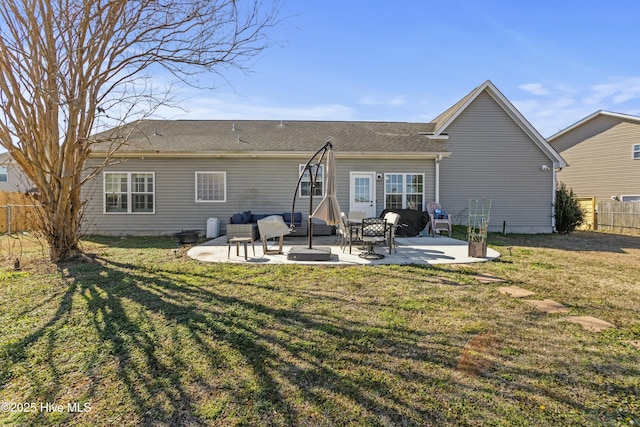 back of property with a yard and a patio