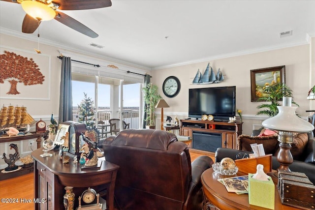 living room featuring hardwood / wood-style flooring, ceiling fan, ornamental molding, and french doors