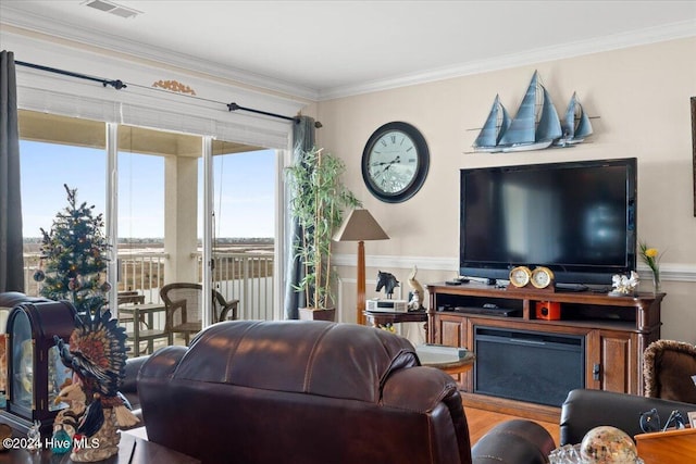 living room with wood-type flooring and ornamental molding