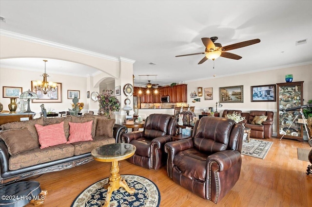 living room featuring ceiling fan with notable chandelier, light wood-type flooring, and ornamental molding