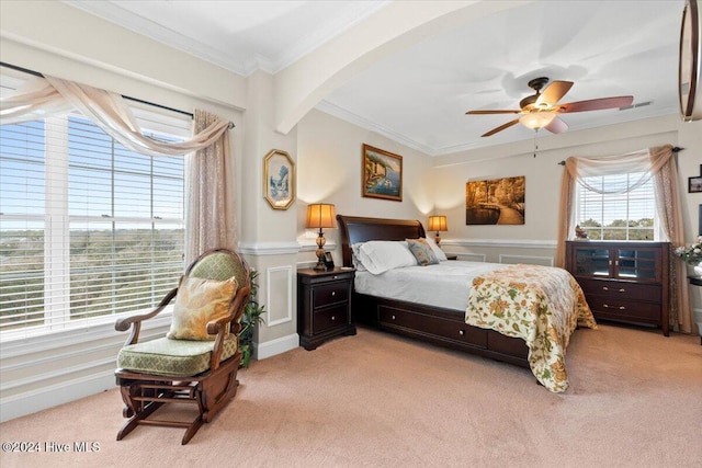 carpeted bedroom featuring ceiling fan and ornamental molding