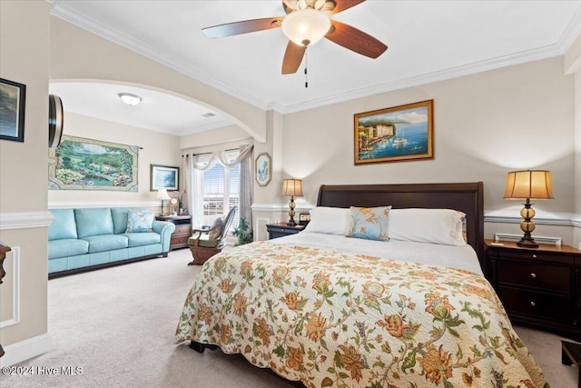 bedroom with light colored carpet, ceiling fan, and crown molding