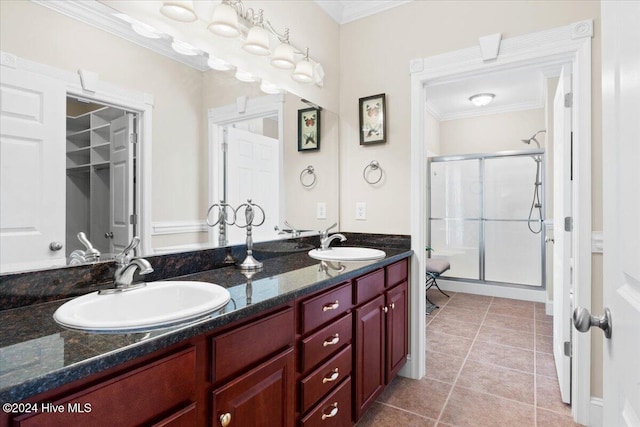 bathroom featuring vanity, tile patterned floors, walk in shower, and ornamental molding