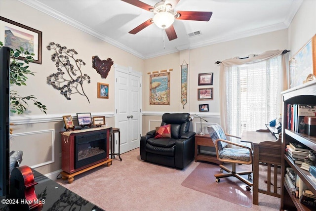 carpeted home office featuring ceiling fan and crown molding