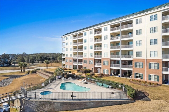 view of property featuring a community pool