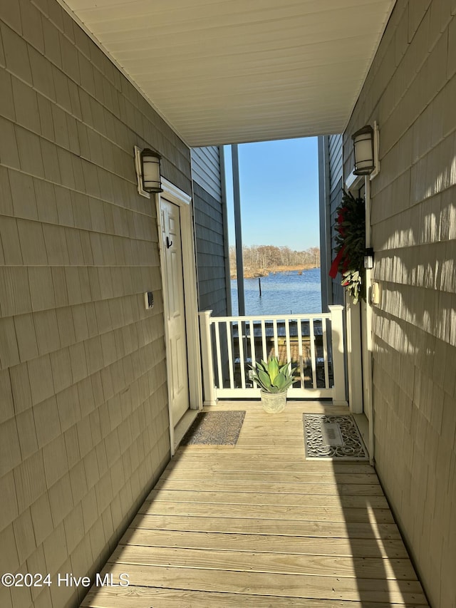 wooden deck featuring covered porch and a water view