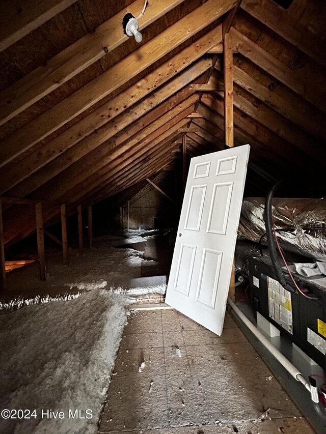 bathroom with lofted ceiling and hardwood / wood-style flooring