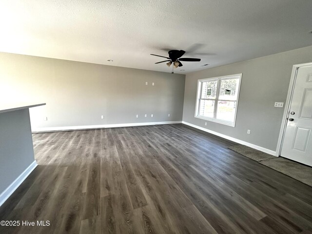 bonus room featuring ceiling fan, vaulted ceiling, and dark colored carpet