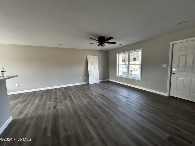 kitchen featuring hardwood / wood-style flooring, kitchen peninsula, light stone countertops, and a textured ceiling