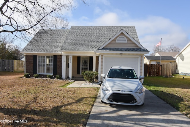 single story home with a garage and a front lawn