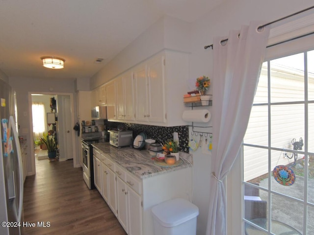 kitchen featuring white cabinetry, dark wood-type flooring, tasteful backsplash, refrigerator, and stainless steel electric range