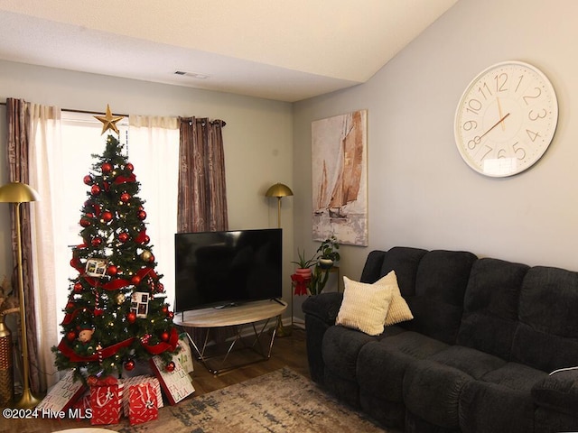 living room featuring hardwood / wood-style floors and vaulted ceiling