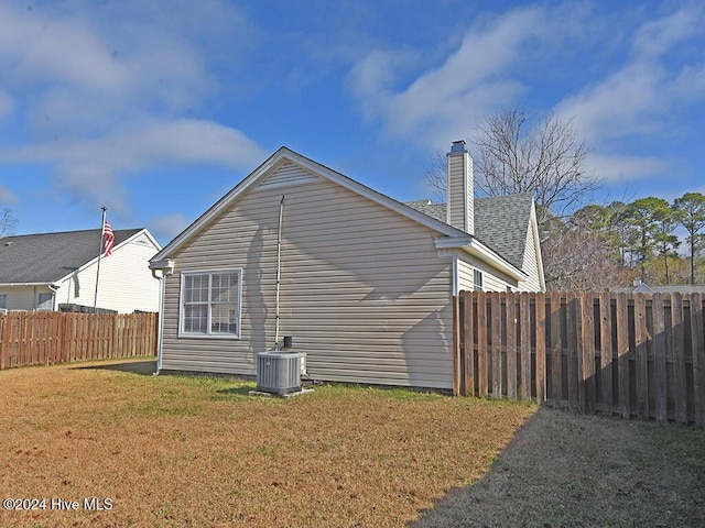 view of home's exterior featuring central air condition unit and a lawn