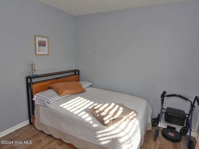 bedroom with hardwood / wood-style floors