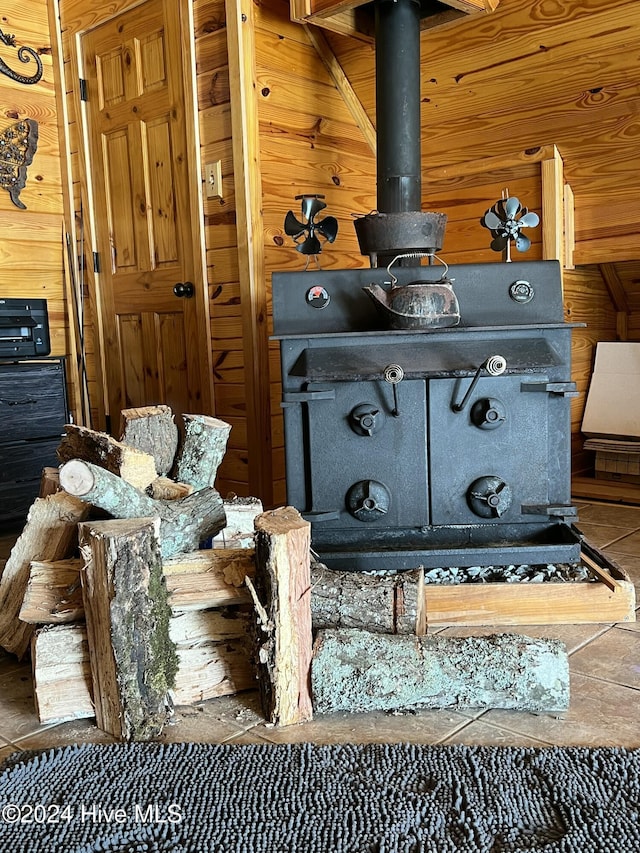 interior details with a wood stove and wood walls