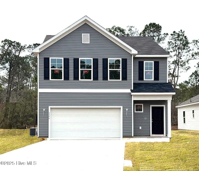 view of front of house featuring a front lawn, central air condition unit, an attached garage, and concrete driveway