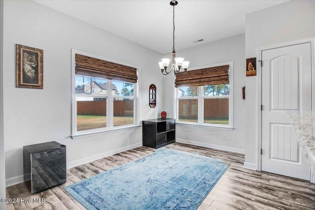 dining space featuring hardwood / wood-style floors and a notable chandelier