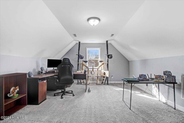 office area featuring light colored carpet and vaulted ceiling