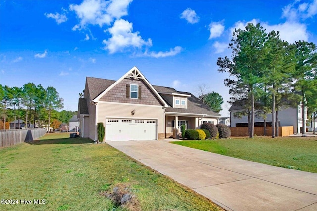 craftsman inspired home featuring a garage and a front lawn