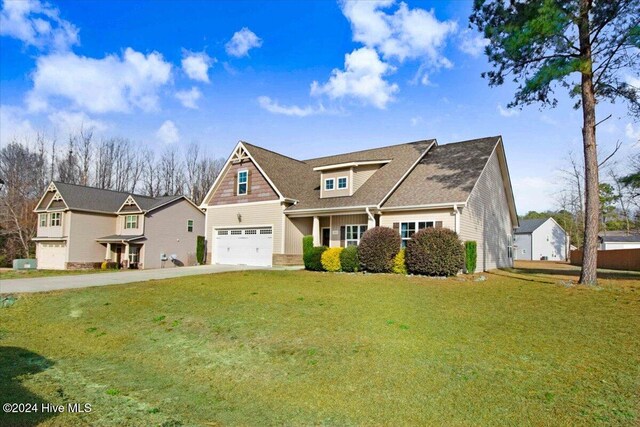 craftsman-style home featuring a front lawn and a garage