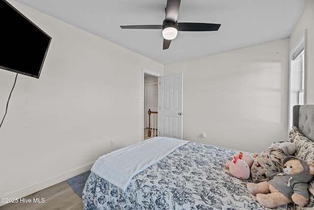 bedroom featuring hardwood / wood-style floors and ceiling fan