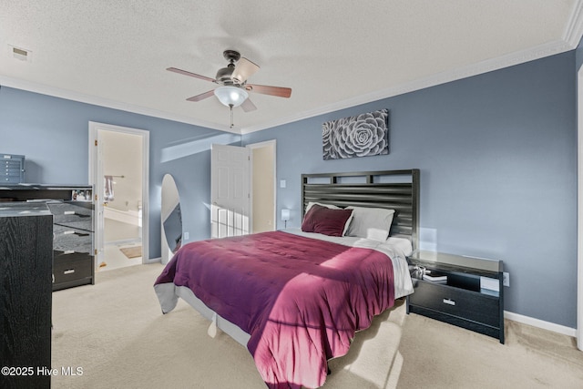 carpeted bedroom featuring ceiling fan, ensuite bath, ornamental molding, and a textured ceiling