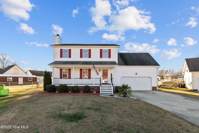 view of front of property with a porch, a garage, and a front lawn