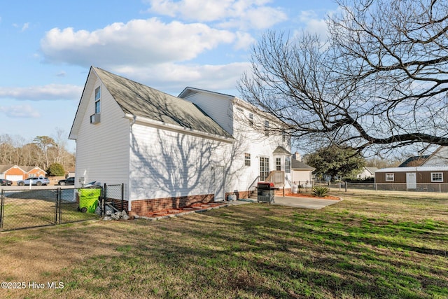 view of side of property featuring a patio and a yard