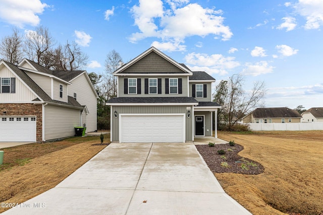 view of front of property featuring a front lawn and a garage