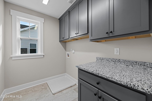 clothes washing area featuring cabinets and washer hookup