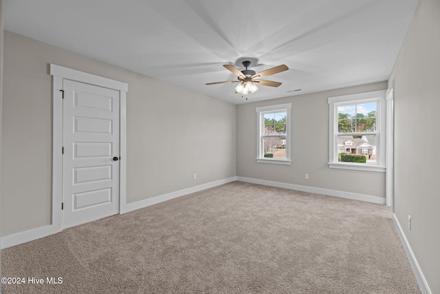 unfurnished room with light carpet and ceiling fan