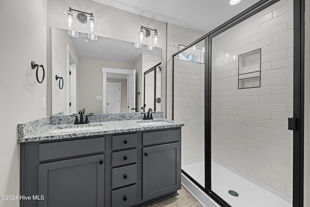 bathroom featuring vanity and a shower with shower door