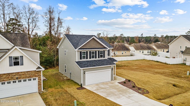 view of front of property with a front yard and a garage