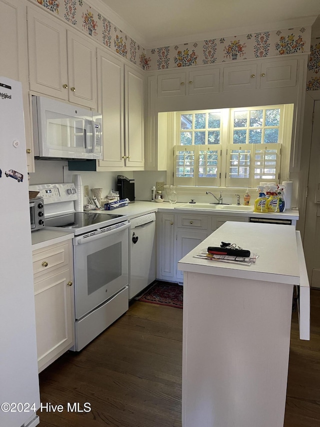 kitchen featuring sink, dark wood-type flooring, plenty of natural light, white appliances, and white cabinets