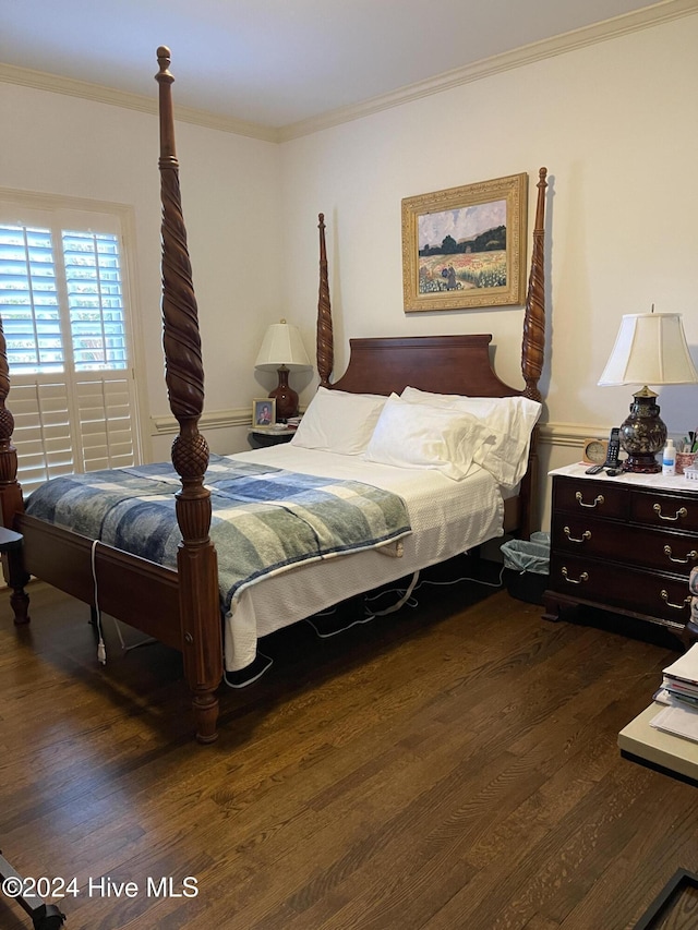 bedroom featuring dark hardwood / wood-style floors and crown molding