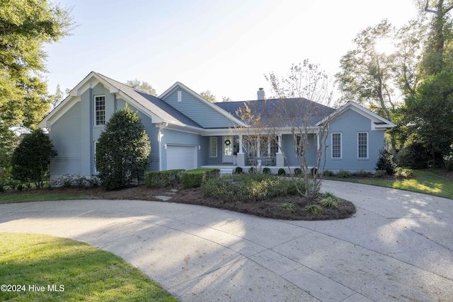 ranch-style house with covered porch and a garage